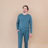 Male model standing with hand in pocket while wearing Men's Jogger Set in Atlantic