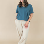 Smiling model wearing Kyte Women's V Neck in Atlantic