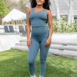Female modeling the Bamboo Flex Bra Tank in Atlantic paired with the matching bamboo flex leggings

