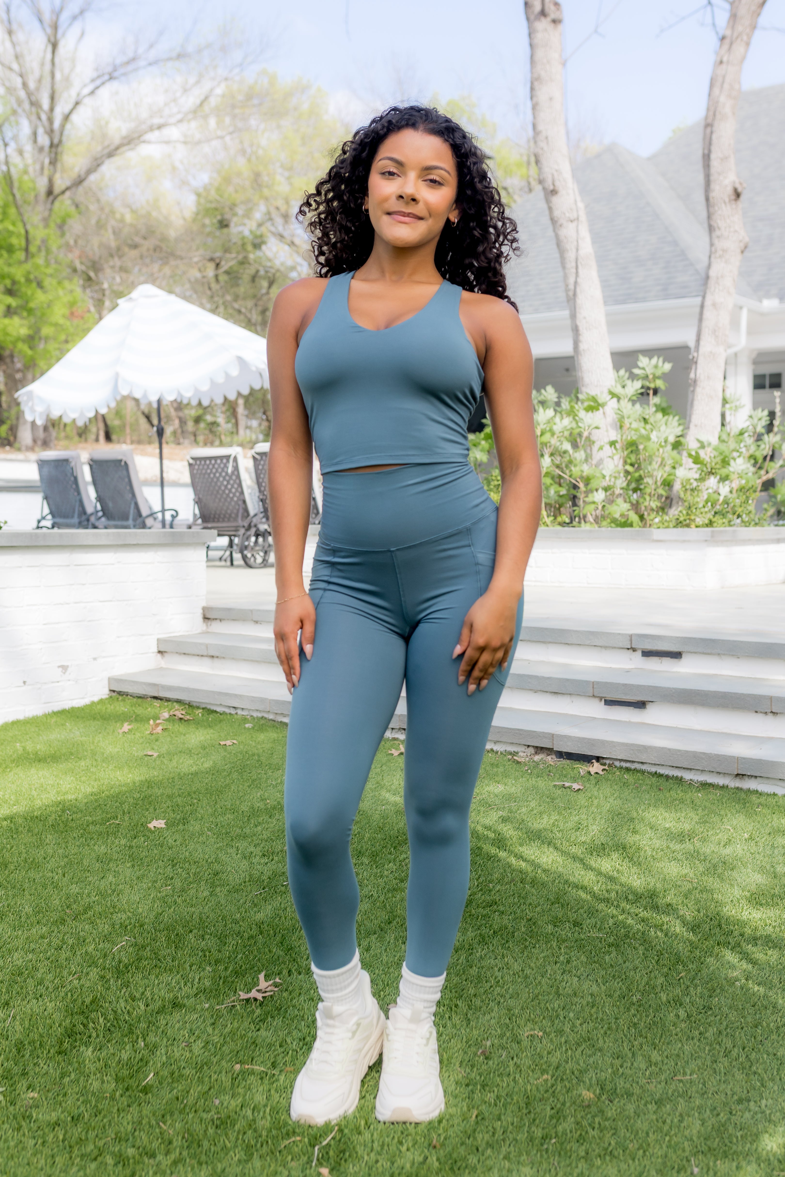 Female modeling the Bamboo Flex Bra Tank in Atlantic paired with the matching bamboo flex leggings

