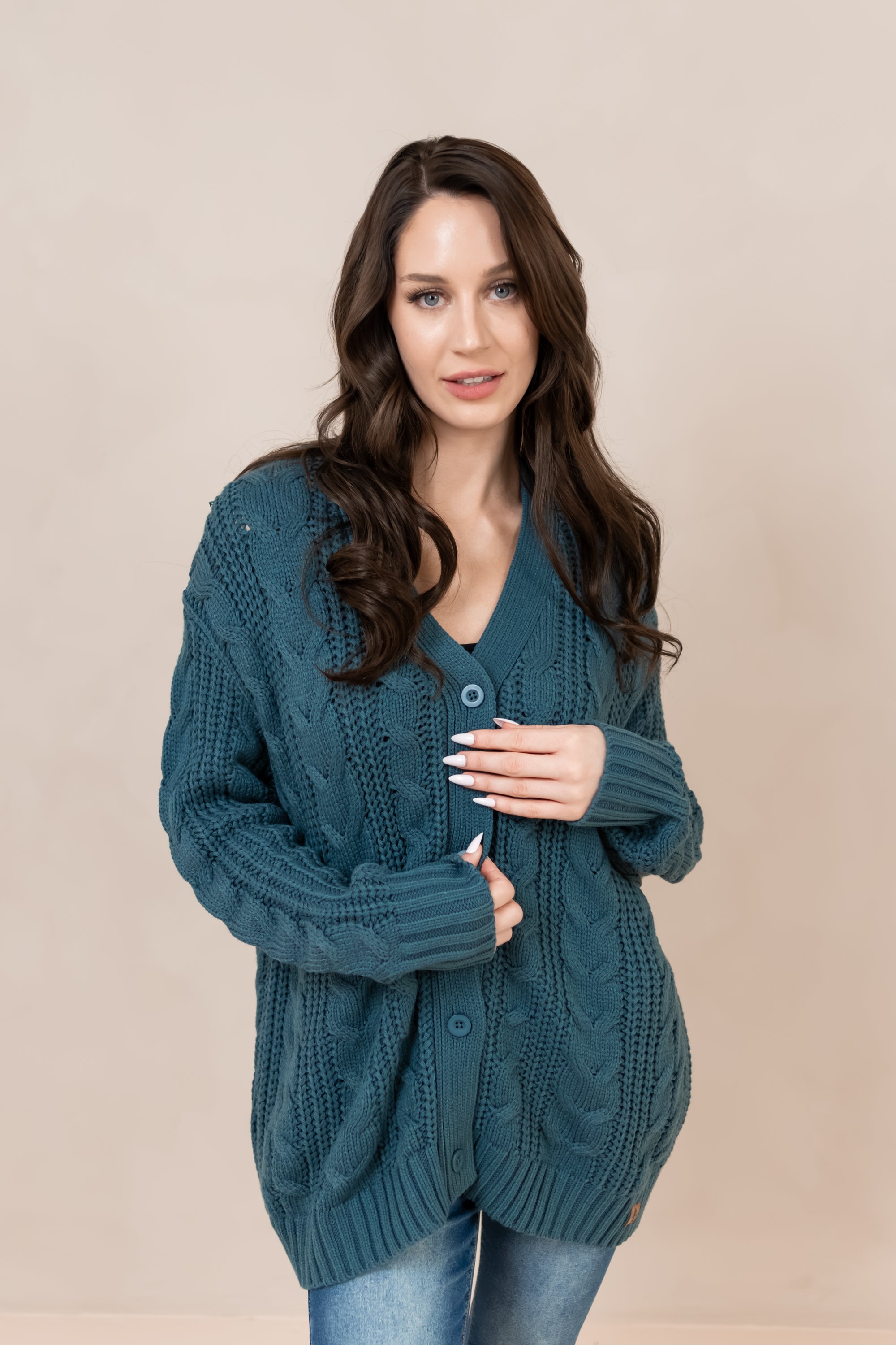 Woman modeling the buttoned up Chunky Cable Knit Cardigan in Atlantic