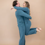 Man wearing the Men's Lounge Pants in Atlantic while holding smiling woman in matching pajama set 