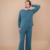 Male model with head on shoulder modeling the Men's Lounge Pants in Atlantic and matching Long Sleeve Henley Tee