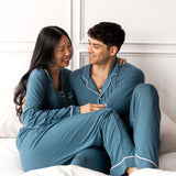 Couple wearing matching bamboo pajamas in a teal color