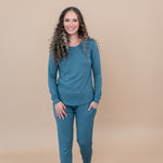 Model stepping forward with hand in pocket while wearing the Women's Jogger Set in Atlantic