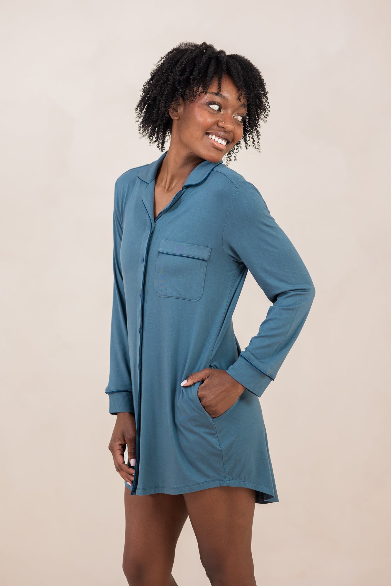 Woman smiling to the side while modeling the Women's Sleep Shirt in Atlantic
