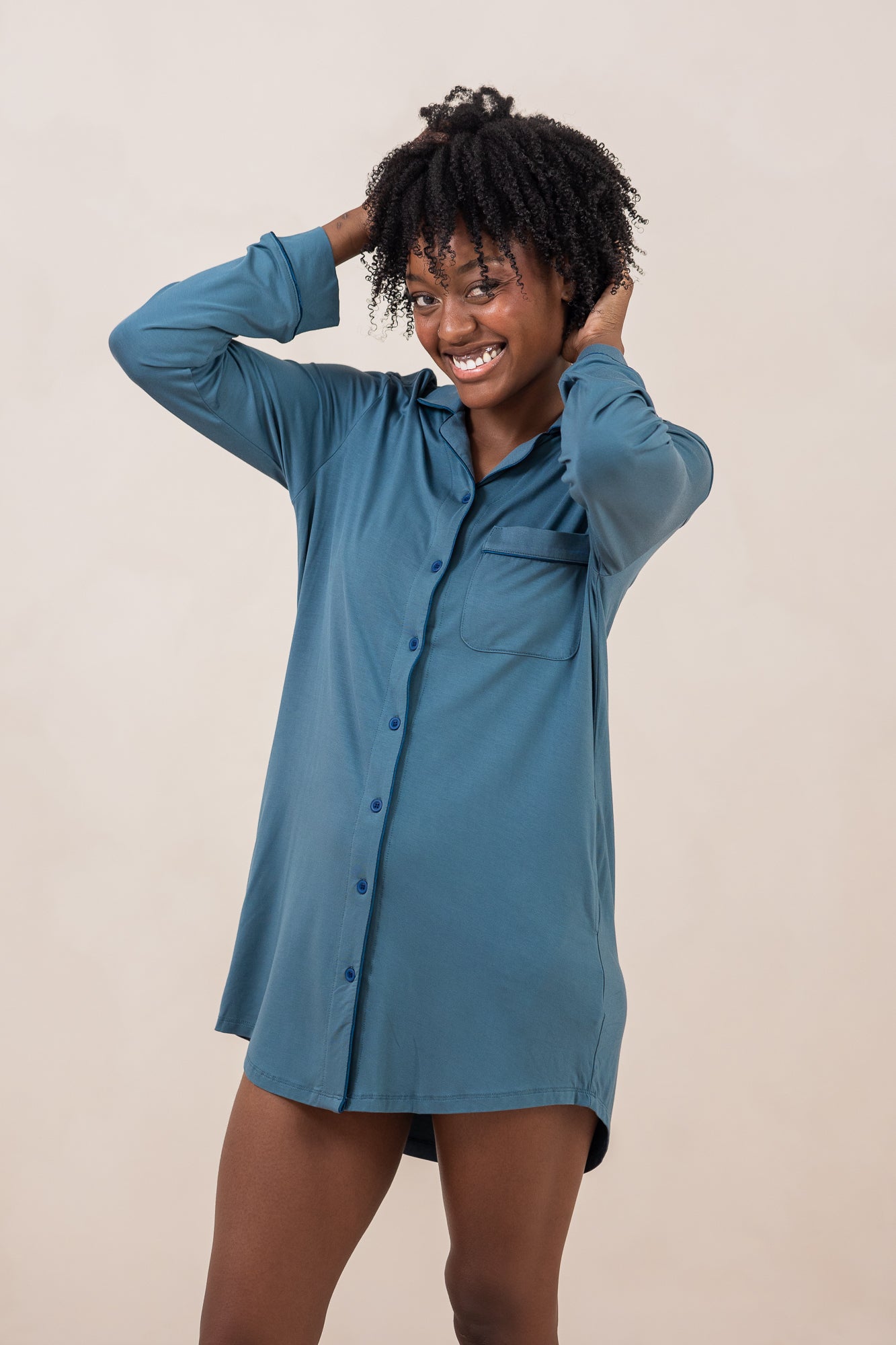 Model with  hands in hair while wearing the Kyte  Women's Sleep Shirt in Atlantic