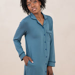 Woman with hand in pocket while modeling the  Kyte Women's Sleep Shirt in Atlantic