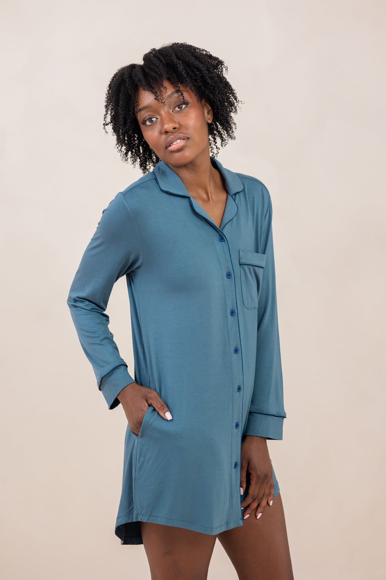 Woman with hand in pocket while modeling the  Kyte Women's Sleep Shirt in Atlantic