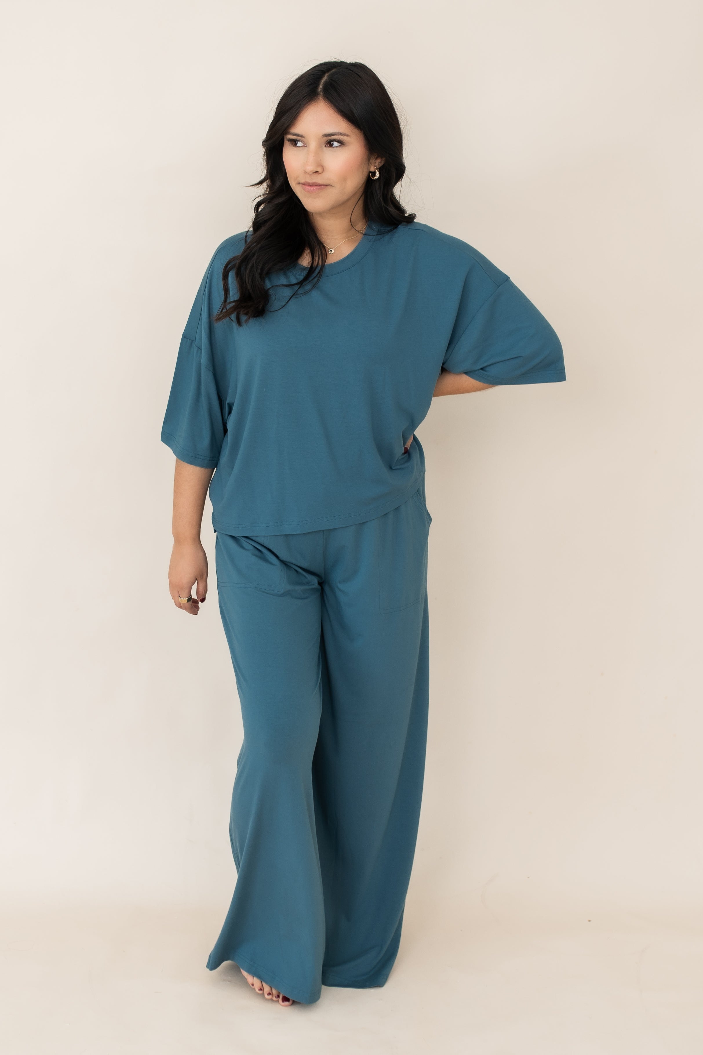 Model looking to the side with hand on her hip while wearing the Bamboo Women's Wide Leg Pant Set in Atlantic