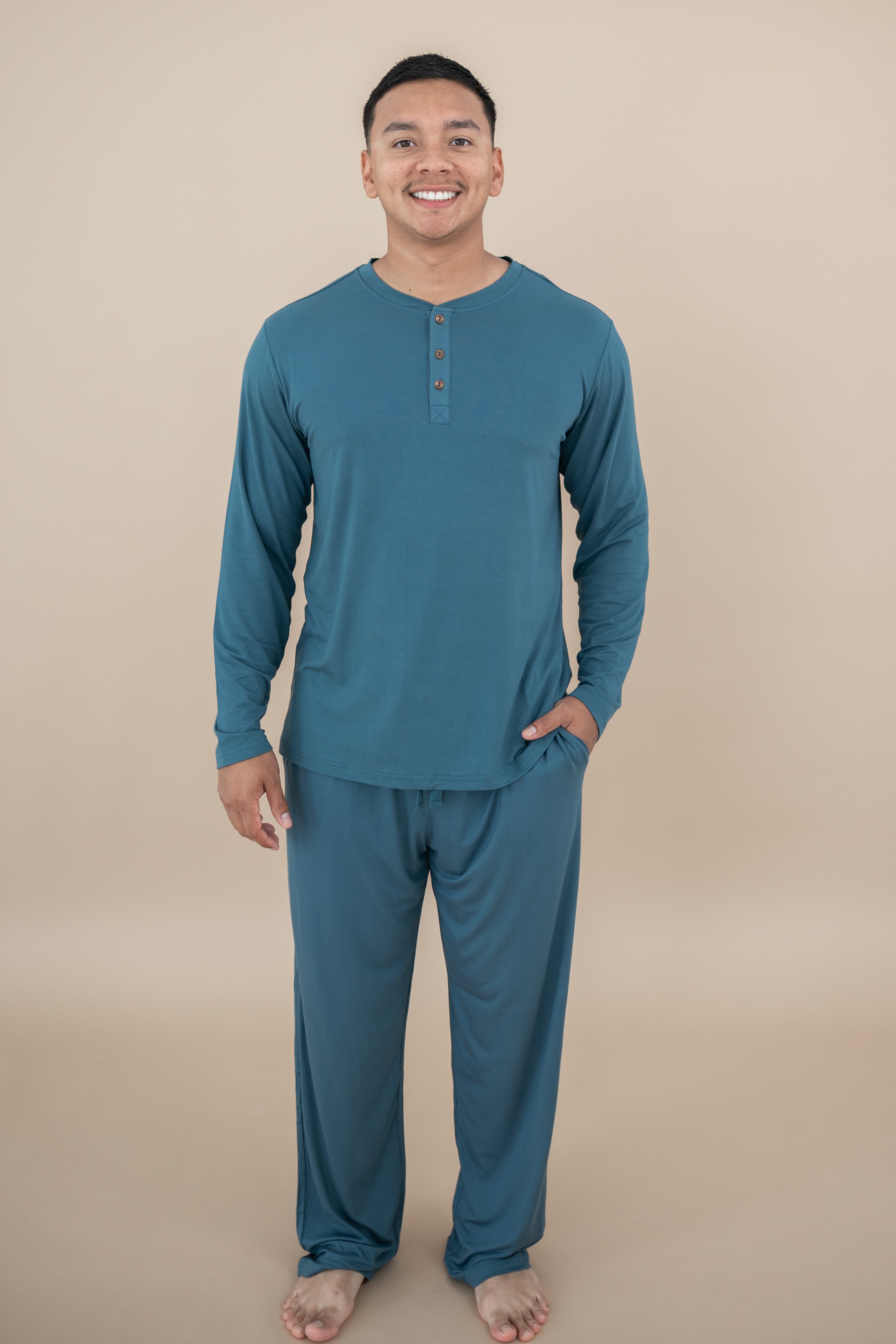 Smiling model wearing Men's Lounge Pants in Atlantic and matching Long Sleeve Henley Top 