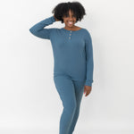 Model with one hand in her hear while wearing the Women’s Ribbed Henley Set in Atlantic