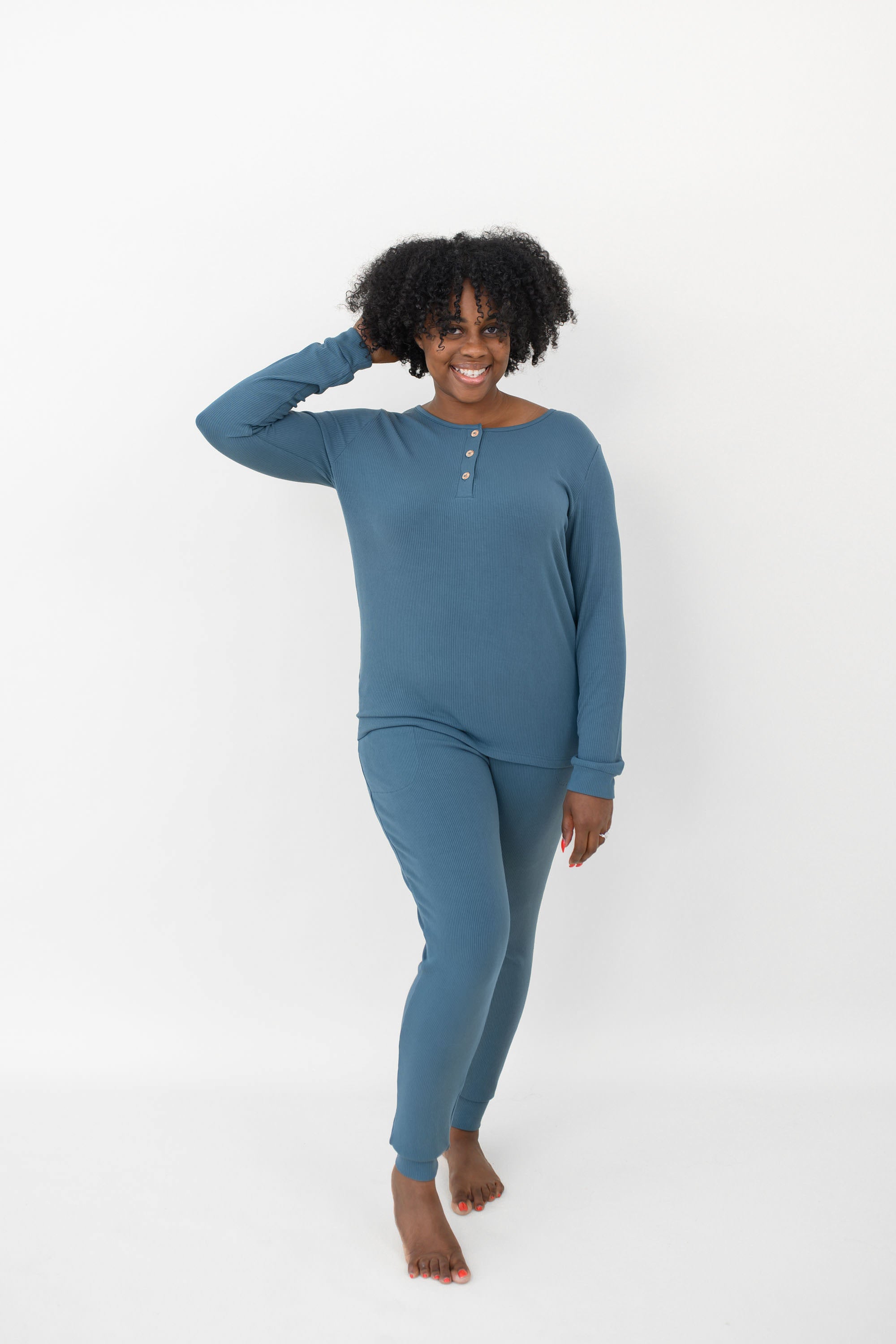 Model with one hand in her hear while wearing the Women’s Ribbed Henley Set in Atlantic