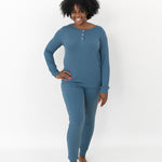 Smiling model wearing the Women’s Ribbed Henley Set in Atlantic with one hand on her hip
