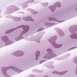 An all-over, monochromatic leopard print with purple spots over a pinkish lilac background color named Thistle.
