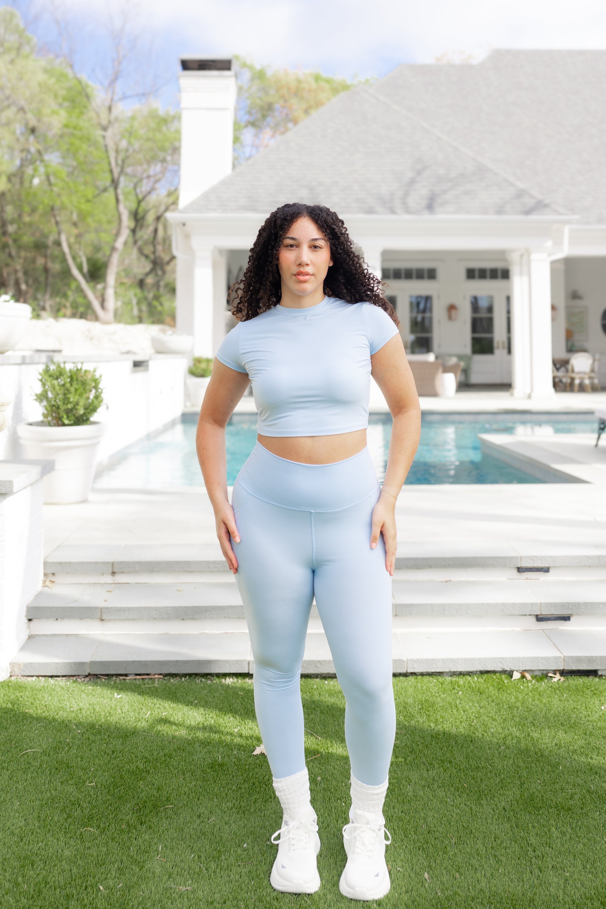 Female posing in front of a pool wearing the Bamboo Flex Baby Tee in Breeze with matching bamboo flex leggings

::: Model is 5'9" wearing size L ///