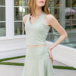Female model posing wearing the Bamboo Flex Skort in Basil with matching bra tank

::: Model is 5'6" wearing size S ///