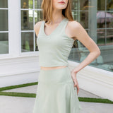 Woman modeling the Bamboo Flex Bra Tank in Basil with matching Basil skort
::: Model is 5'6" wearing size S ///