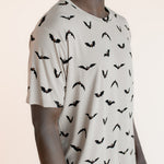 Close up of Modal wearing Men's Crew Neck Tee in Bats print on a beige background