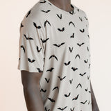 Close up of Modal wearing Men's Crew Neck Tee in Bats print on a beige background