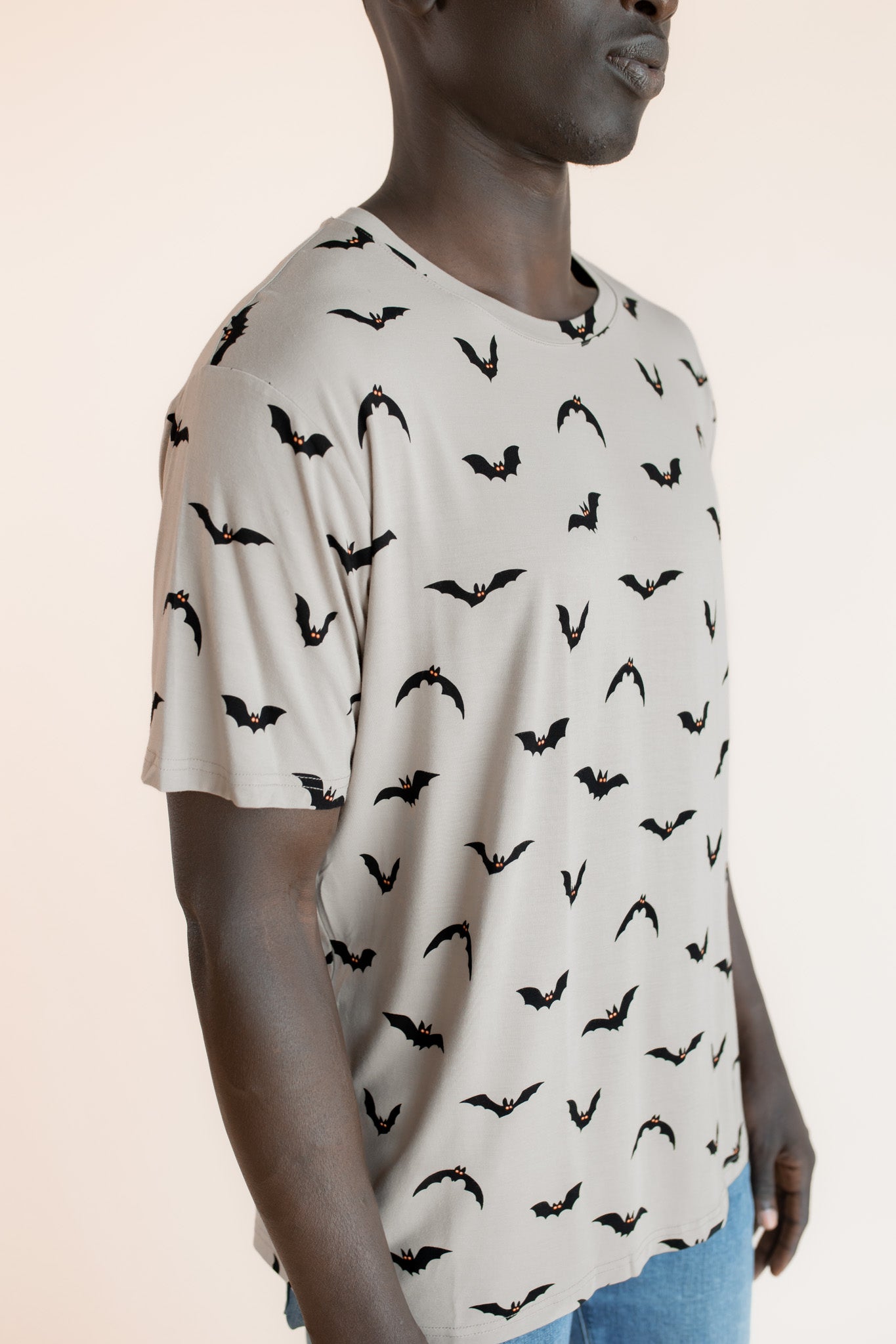 Close up of Modal wearing Men's Crew Neck Tee in Bats print on a beige background