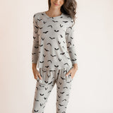 Modal posing in Women's Jogger Pajama Set in Bats print on a white background