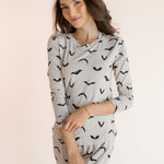 Modal smiling in Women's Jogger Pajama Set in Bats print on a white background