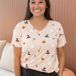 Model smiling with hand in pocket while wearing the Women's V-Neck in Bewitched