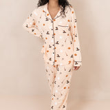 Smiling model standing with hand on her hip while wearing the Kyte Women's Long Sleeve Pajama Set in Bewitched