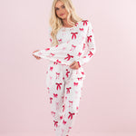 Model stretching bottom of top on the Bamboo Women's Jogger Pajama Set in Big Love Bow