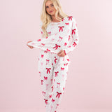 Model stretching bottom of top on the Bamboo Women's Jogger Pajama Set in Big Love Bow