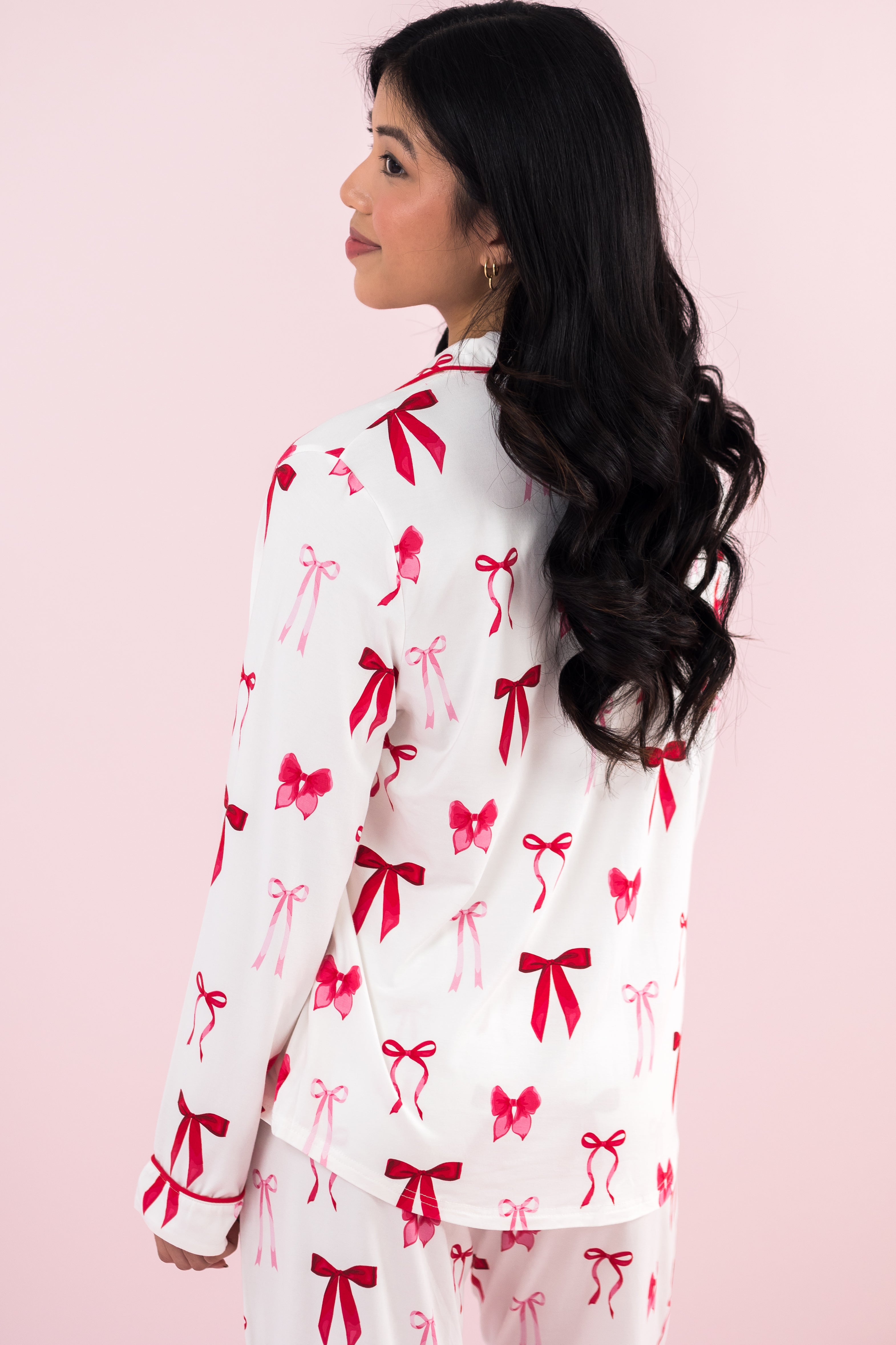 Model showing the back of the Kyte Bamboo Long-Sleeved Women's Pajama Set in Big Love Bow