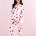 Smiling model wearing the Bamboo Long-Sleeved Women's Pajama Set in Big Love Bow
