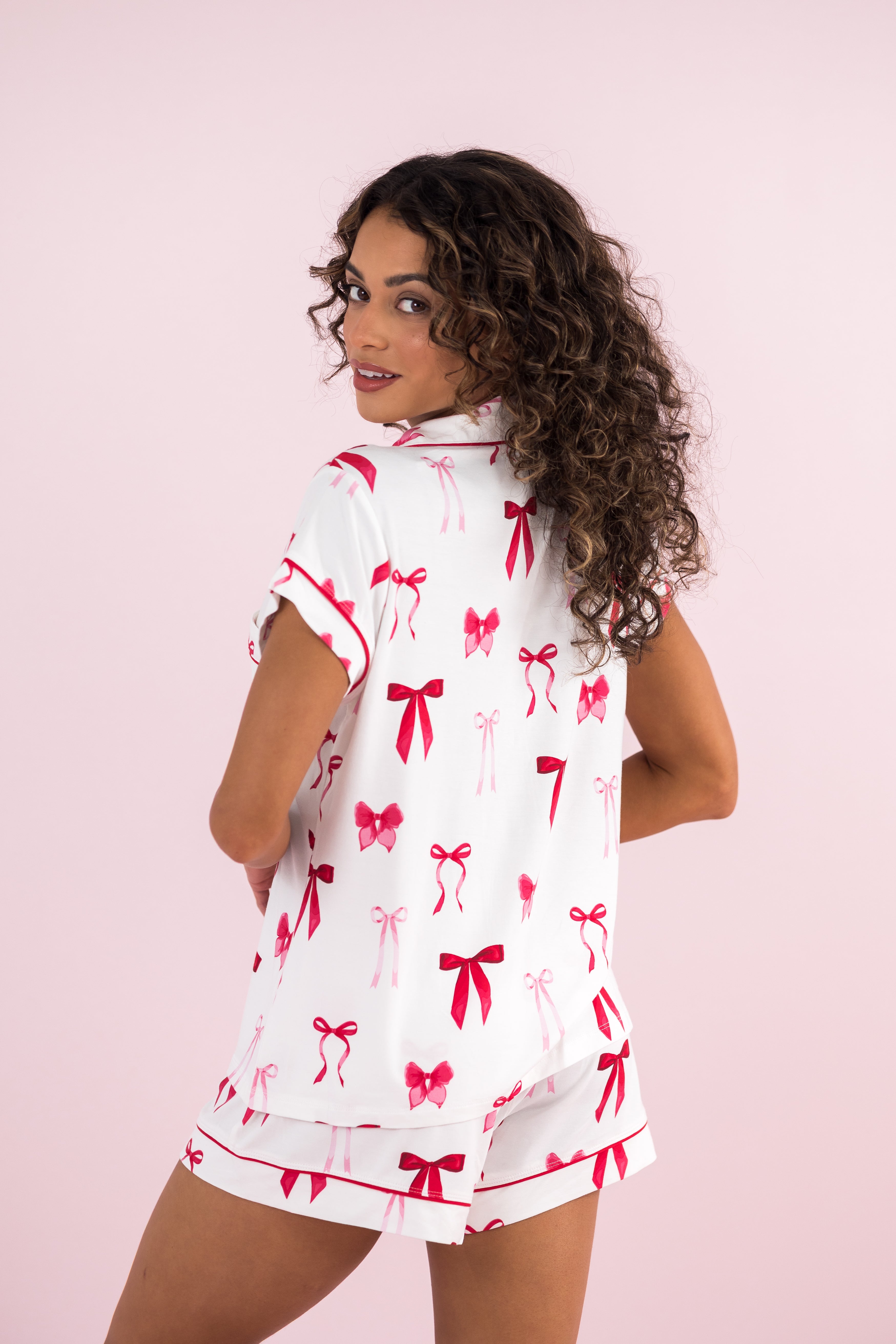 Model showing the back of the Bamboo Women's Short Sleeve Pajama Set in Big Love Bow