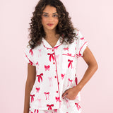 Model wearing the Bamboo Women's Short Sleeve Pajama Set in Big Love Bow with hand on hip