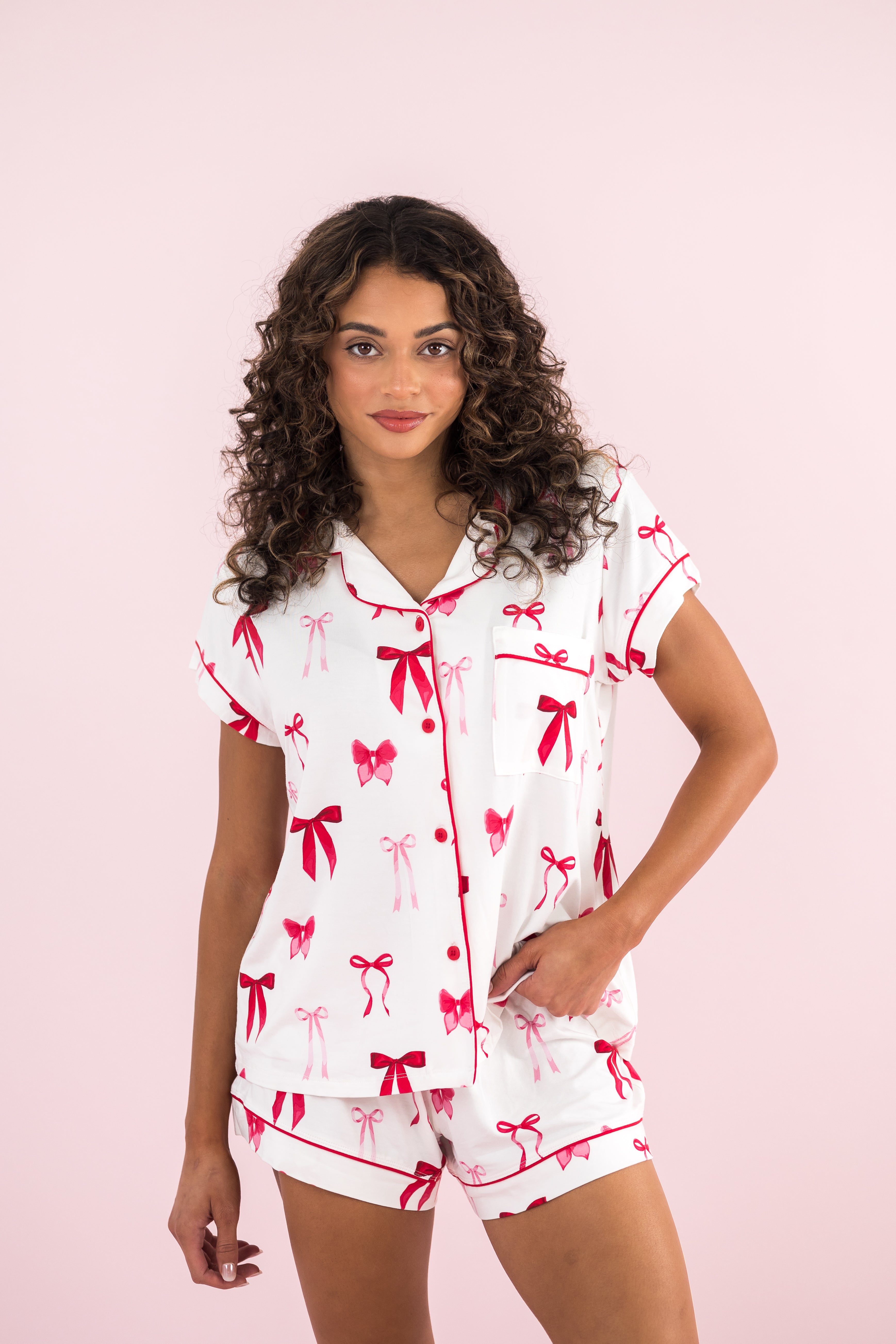 Model wearing the Bamboo Women's Short Sleeve Pajama Set in Big Love Bow with hand on hip