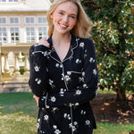 Model outside smiling with her hand over her shoulder wearing a long sleeve pajama set in midnight magnolia.

::: Model is 5'9" wearing size XS ///


