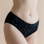 Close up of the Women’s Underwear in Midnight Leopard on a model paired with bra in cloud 

::: Model is 5'8" wearing size M ///