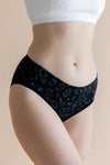 Close up of the Women’s Underwear in Midnight Leopard on a model paired with bra in cloud 

::: Model is 5'8" wearing size M ///