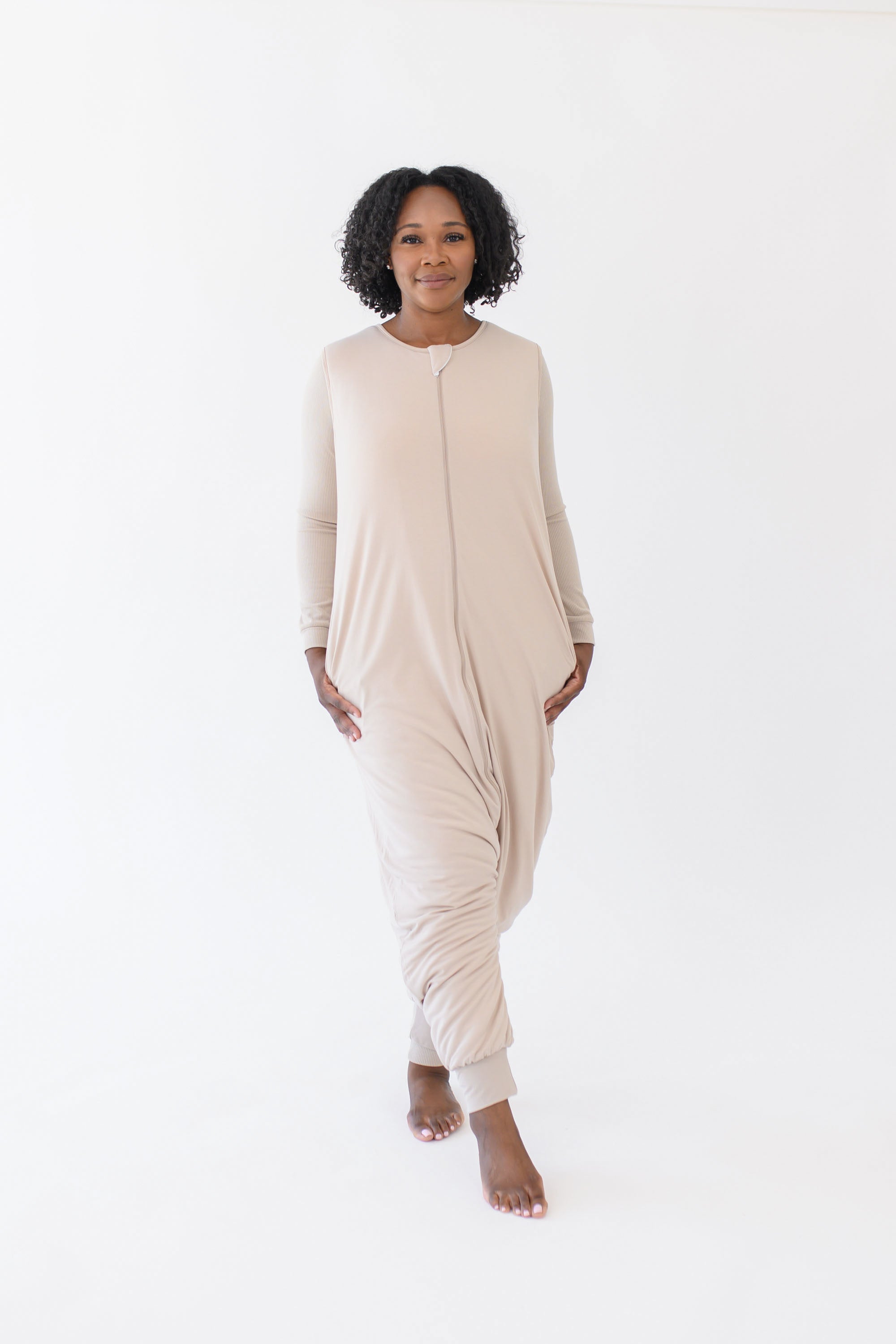 Model wearing the Adult Sleep Bag Walker in Bisque with hands to the side