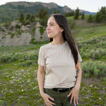 Model looking to the side with hands on hips wearing Kyte Woman's Crew Neck in Bisque 