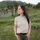 Model looking to the side with hands on hips wearing Kyte Woman's Crew Neck in Bisque 