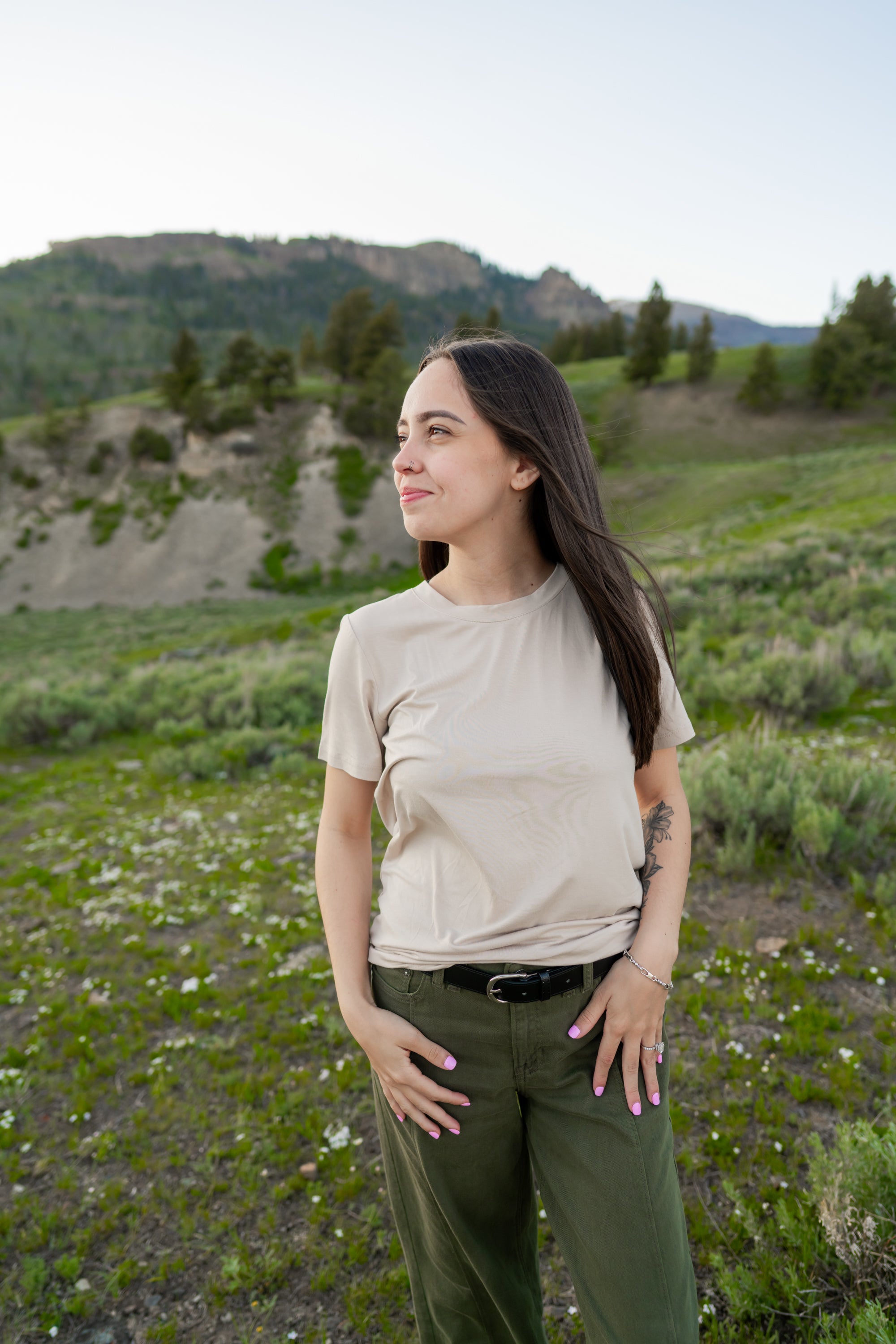 Model looking to the side with hands on hips wearing Kyte Woman's Crew Neck in Bisque 