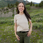 Close up of smiling model wearing the Woman's Crew Neck in Bisque 