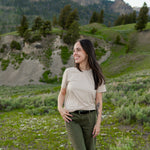Model in Woman's Crew Neck in Bisque paired with green pants and a black belt