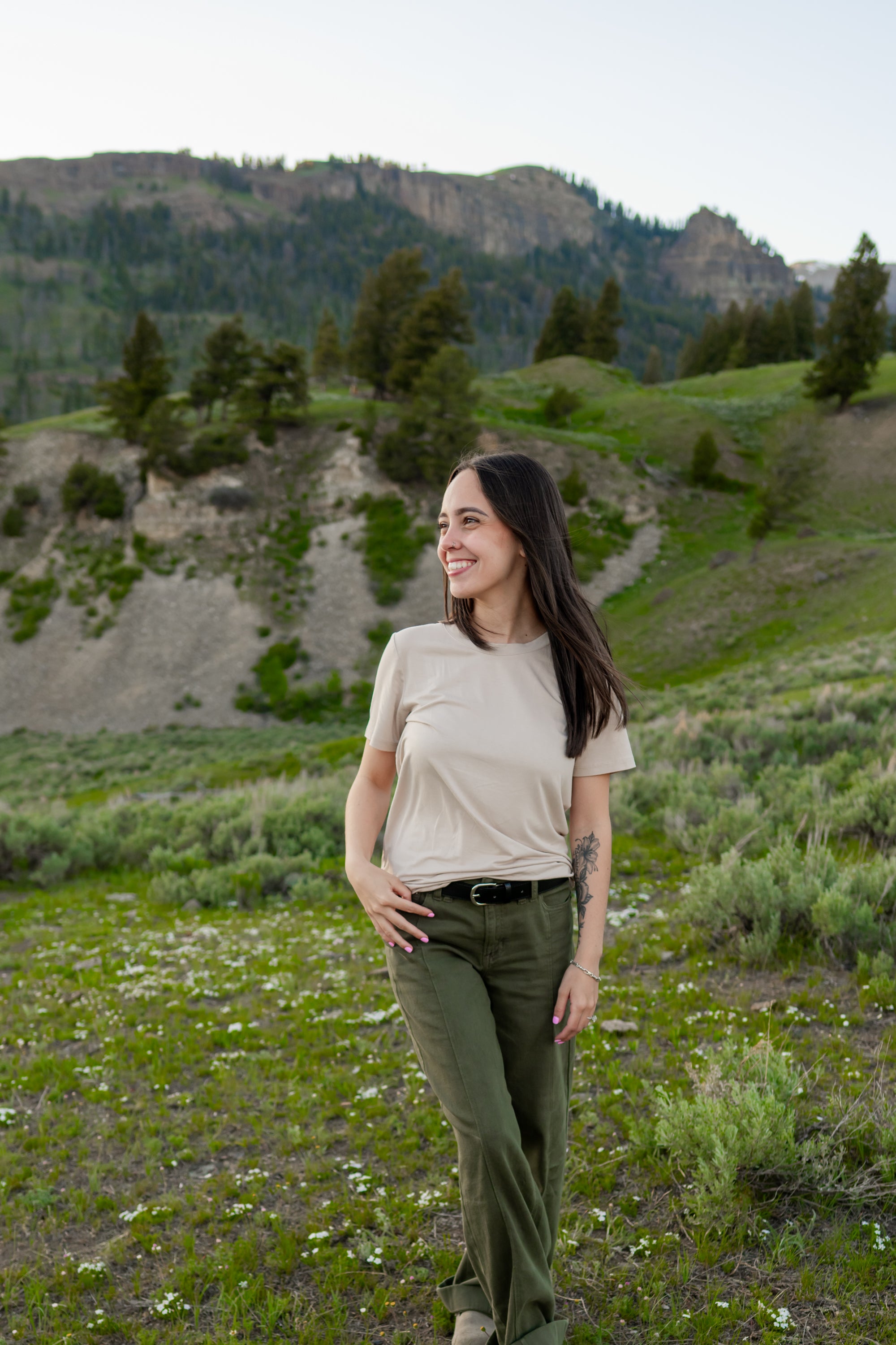 Model in Woman's Crew Neck in Bisque paired with green pants and a black belt