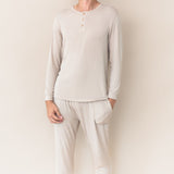 Male model wearing the Men's Ribbed Henley Set in Bisque in front of a cream colored background