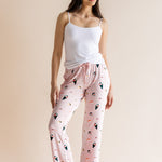 Model wearing pink Women's Lounge Pants in Sushi print under white camisole on a beige background ::: Model is 5'10" wearing size S ///