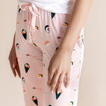 Model in pink Women's Lounge Pants with drawstring in Sushi print under white camisole on a beige background