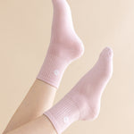 Pink socks worn on a light beige background